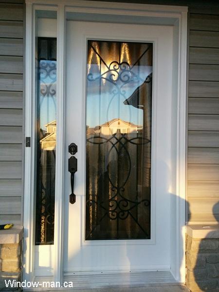 White steel exterior door and sidelight. Blackburn Wrought iron glass inserts. Professional installation